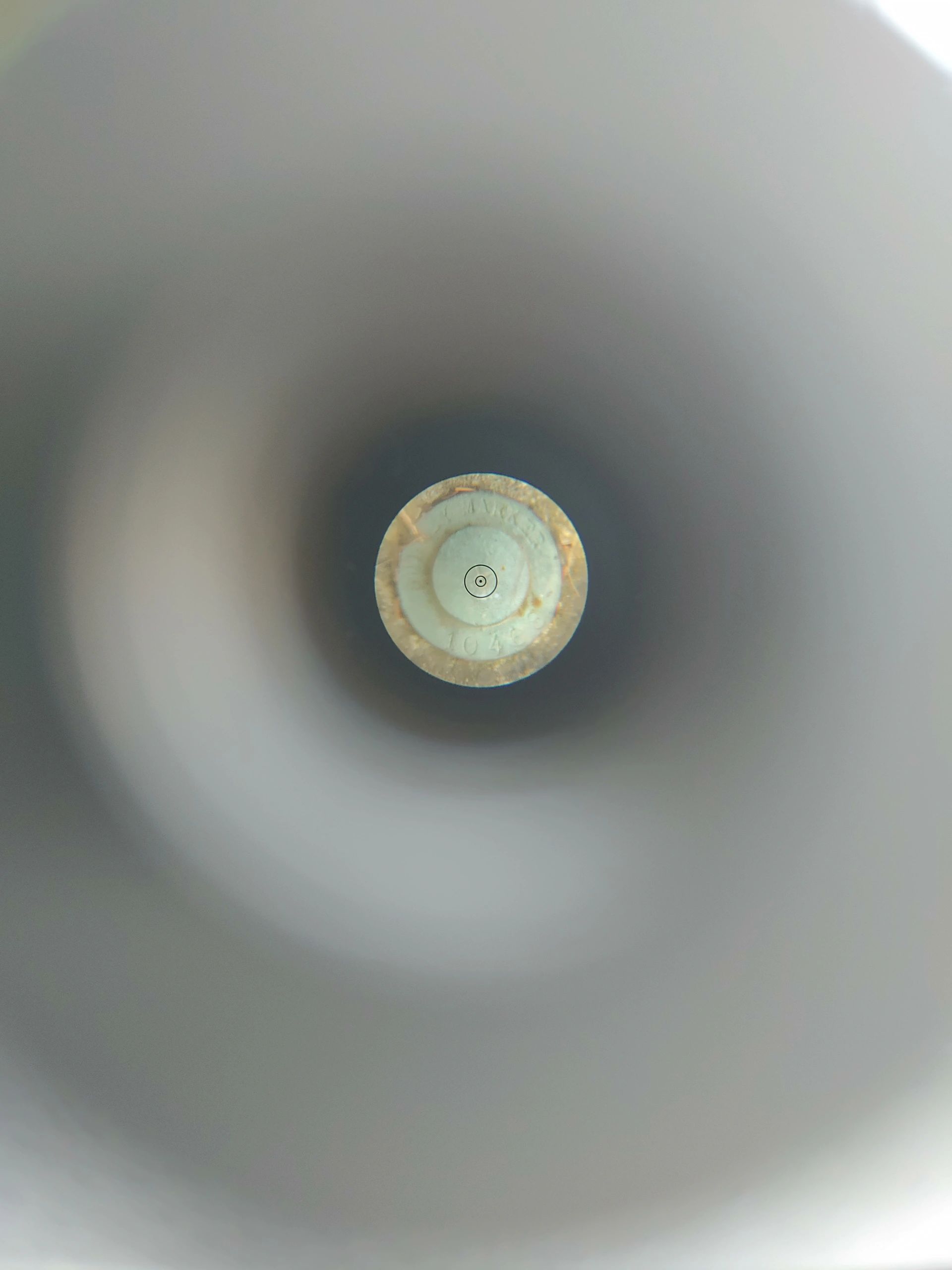 Benchmark viewed through the optical plummet of a surveying tribrach